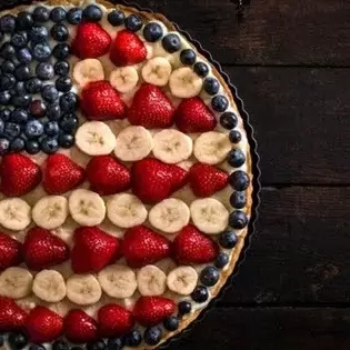 an all-American pie decorated like a flag with fruit toppings. 