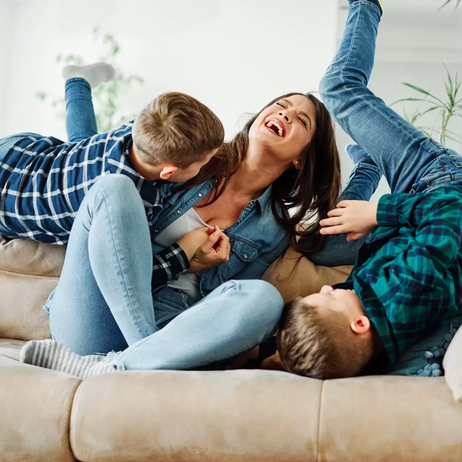 Mom and kids laughing on couch