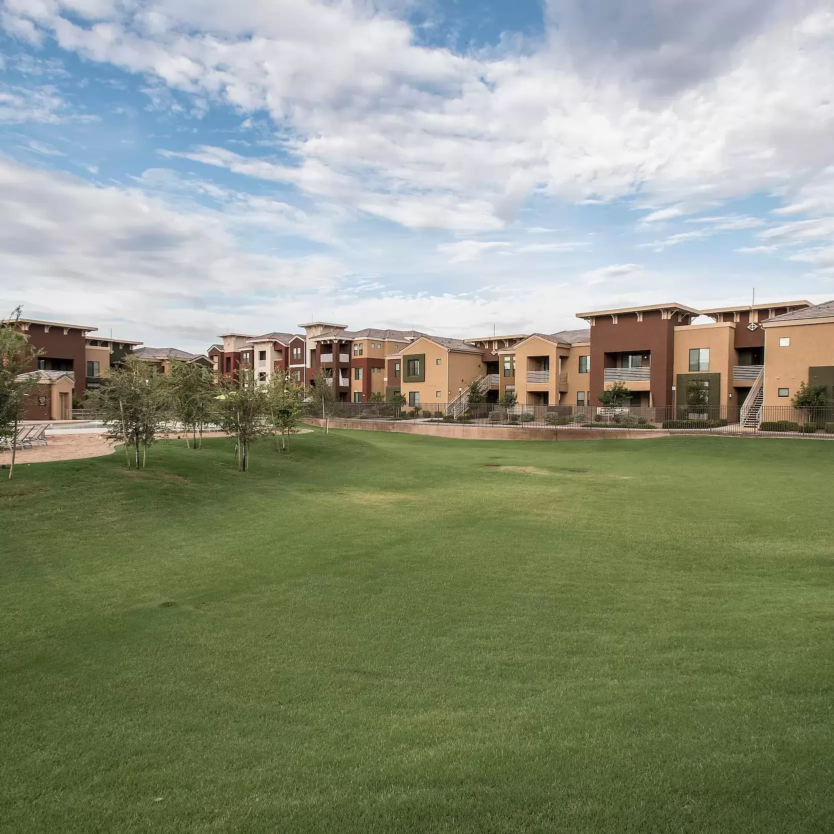 A large grassy field providing a peaceful view at the Gilberts, Az apartment complex.